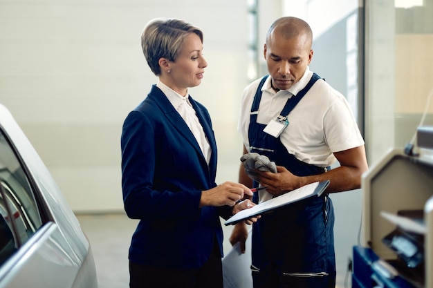 businesswoman-auto-mechanic-analyzing-paperwork-workshop_637285-11584.jpg